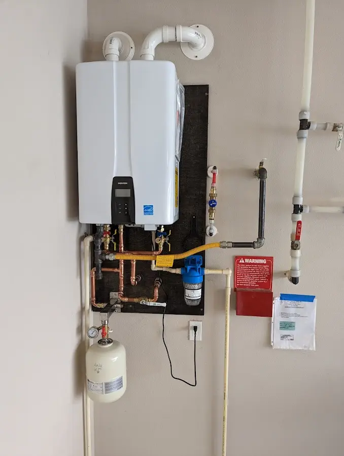 Professional plumber installing copper piping in a Algood home